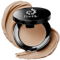 An open black BaeBlu concealer compact with a beige concealer inside, surrounded by decorative swirled makeup smears on a white background.